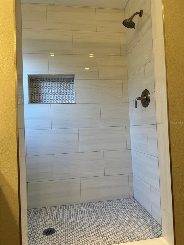 bathroom with tiled shower