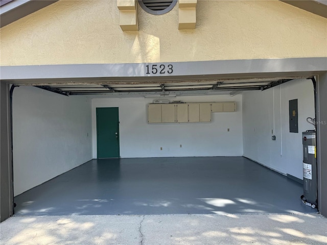 garage with electric water heater and electric panel