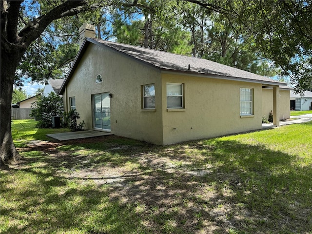 back of house featuring a yard, a patio, and central air condition unit