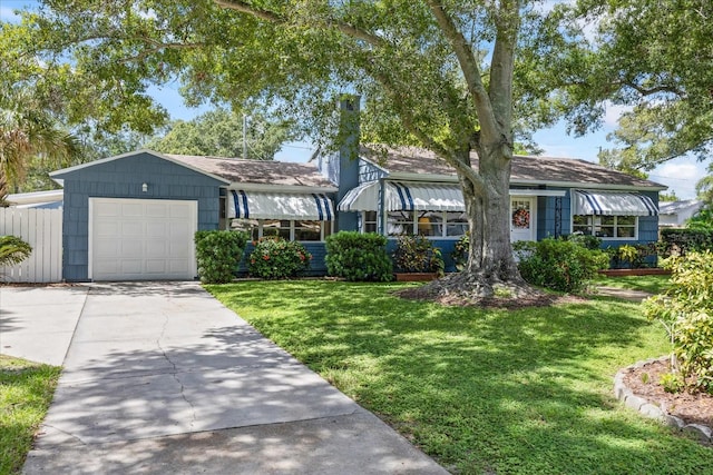 view of front of house with a garage and a front lawn