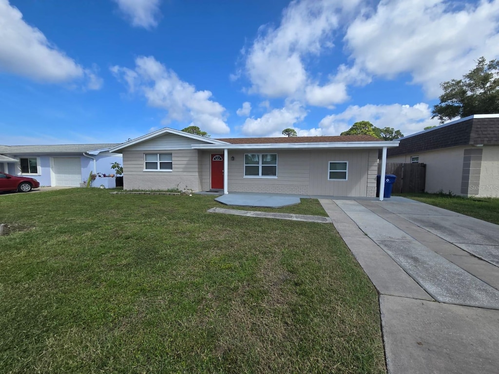 single story home with a garage and a front lawn