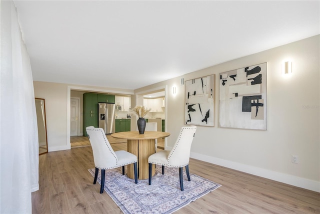 dining space featuring light wood-type flooring