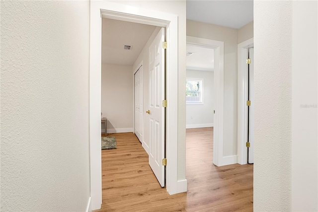 hall with light wood-type flooring