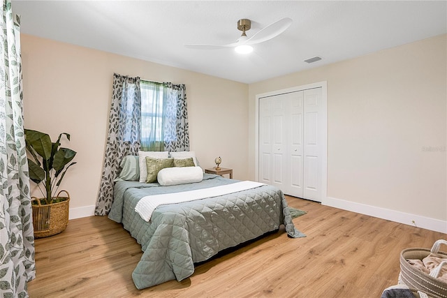 bedroom with a closet, hardwood / wood-style floors, and ceiling fan