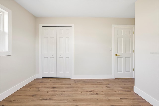 unfurnished bedroom with light hardwood / wood-style floors and a closet