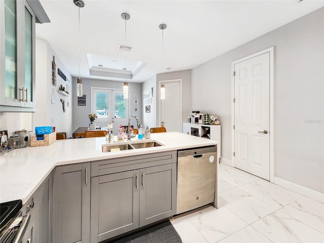 kitchen featuring sink, decorative light fixtures, stainless steel dishwasher, kitchen peninsula, and a raised ceiling