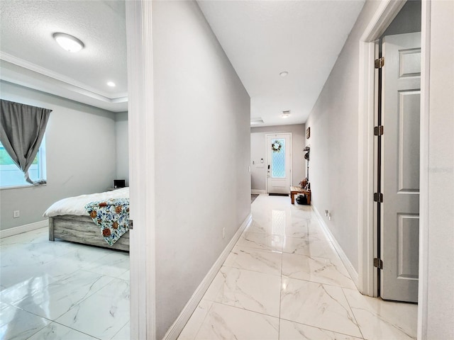 hallway with plenty of natural light and a textured ceiling