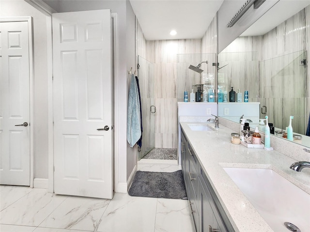 bathroom featuring vanity, a shower with shower door, and tile walls