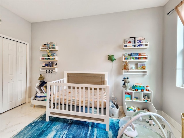 bedroom featuring a crib and a closet