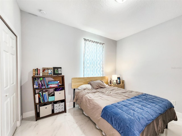 bedroom featuring a closet and a textured ceiling