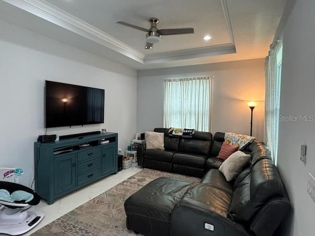 living room featuring crown molding, ceiling fan, and a raised ceiling