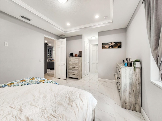 bedroom featuring a raised ceiling and a textured ceiling