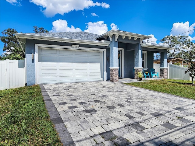 view of front of home featuring a garage and a front lawn