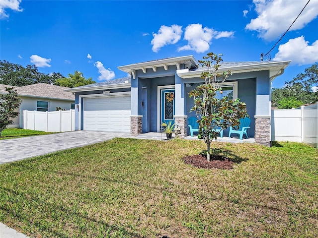 view of front of home featuring a garage and a front lawn