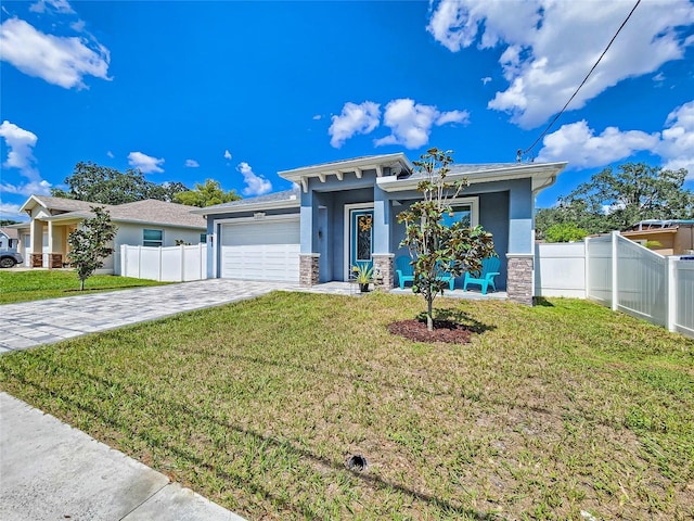 view of front facade with a garage and a front yard