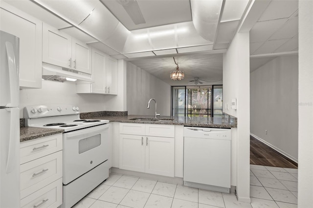 kitchen featuring white appliances, sink, dark stone counters, and white cabinets