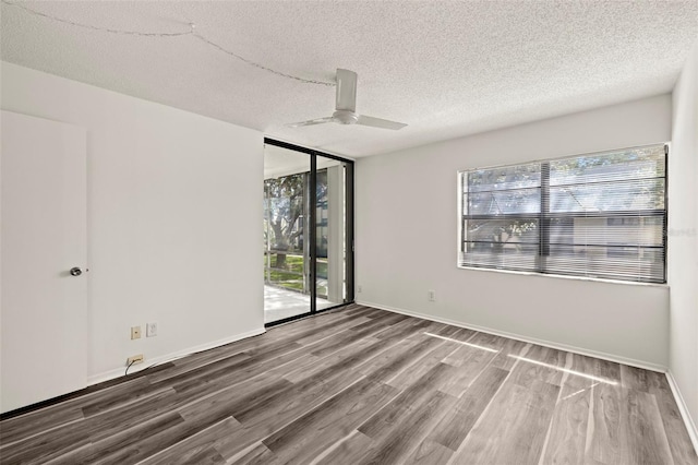 spare room featuring hardwood / wood-style floors, a textured ceiling, and ceiling fan