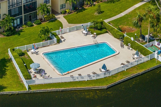 view of swimming pool with a yard and a patio