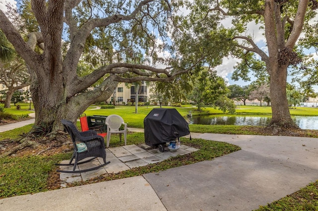 exterior space with a water view and area for grilling