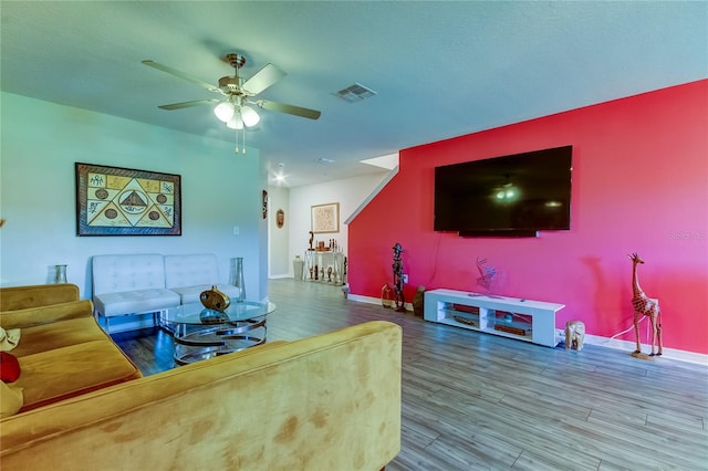 living room featuring ceiling fan and wood-type flooring