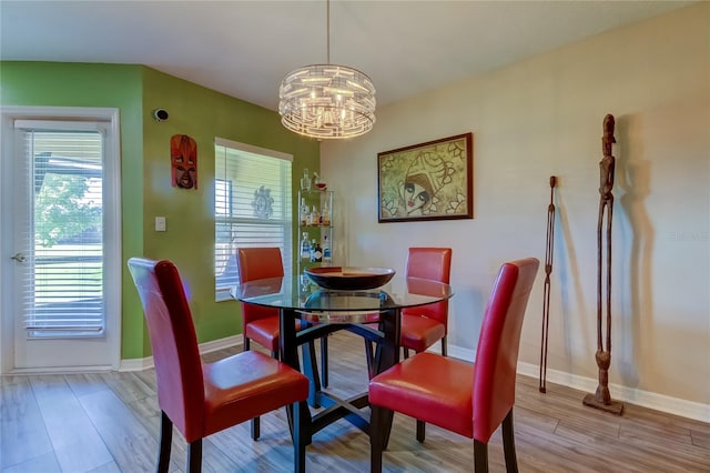 dining space featuring a notable chandelier and light hardwood / wood-style floors