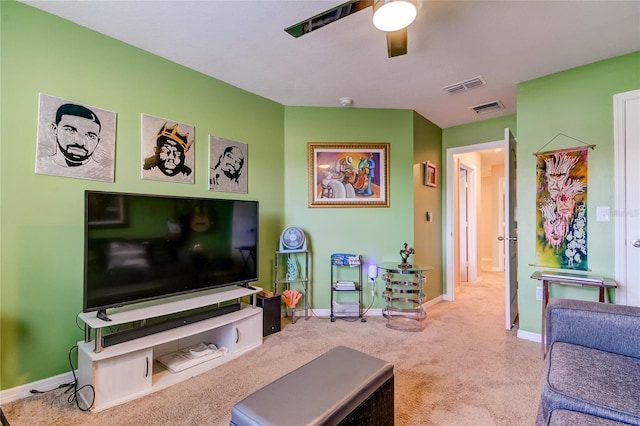 carpeted living room with ceiling fan