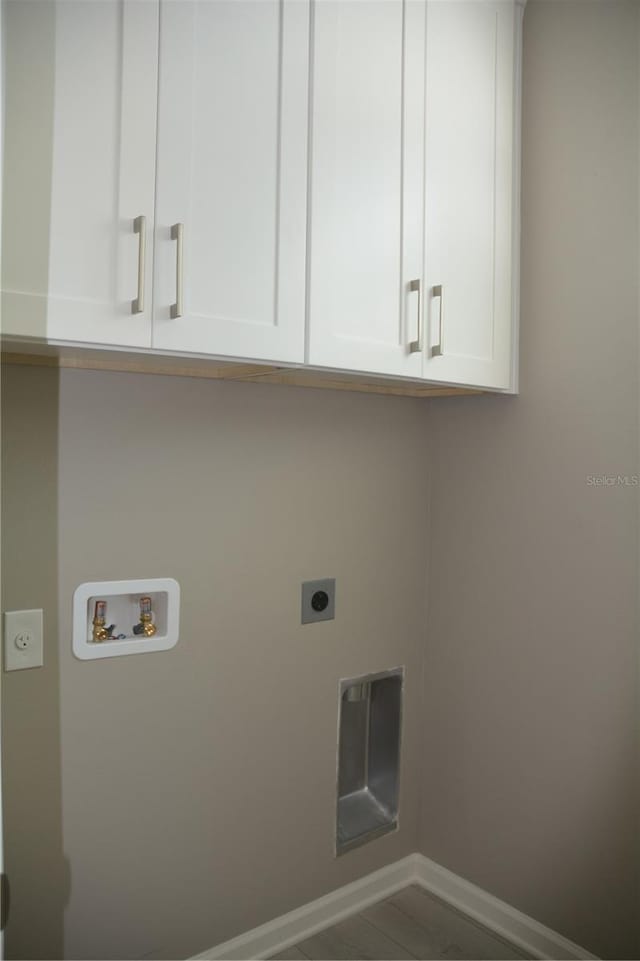 laundry area with hookup for a washing machine, electric dryer hookup, and cabinets