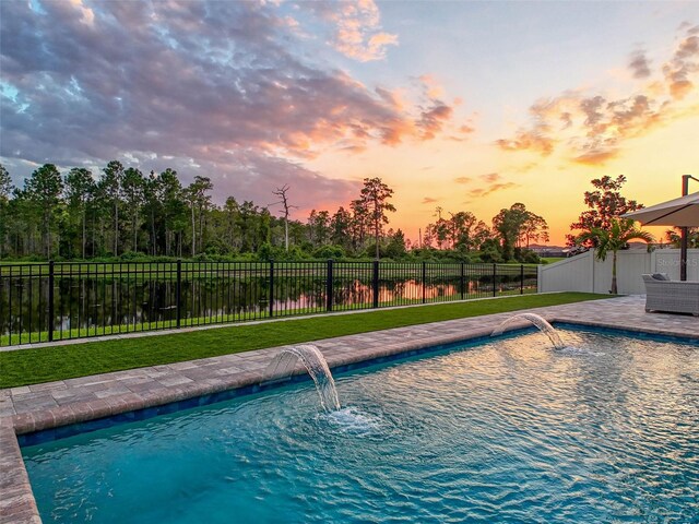 view of swimming pool featuring a fenced in pool, fence, and a lawn