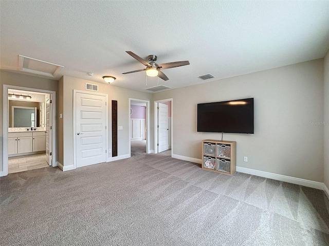 unfurnished living room with visible vents, ceiling fan, and carpet flooring