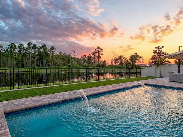 view of swimming pool with a fenced in pool, fence, and a lawn