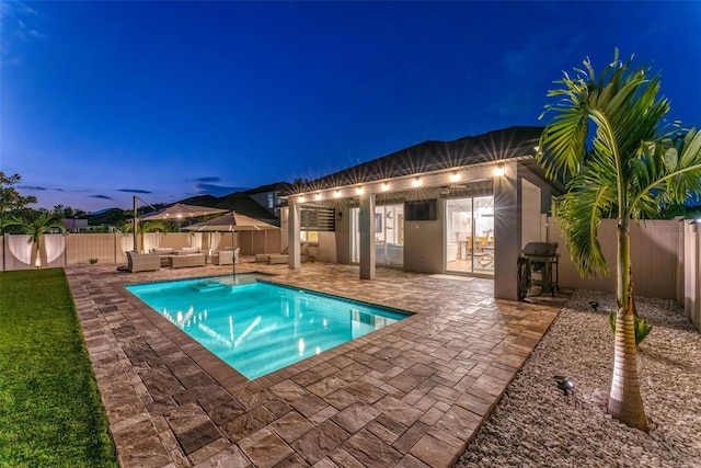 view of swimming pool with a patio area, a fenced in pool, area for grilling, a fenced backyard, and an outdoor hangout area