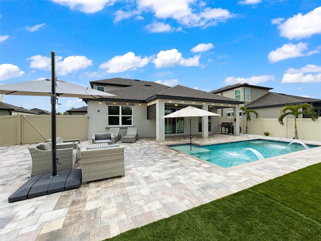rear view of house with stucco siding, a patio, a fenced backyard, a gate, and outdoor lounge area