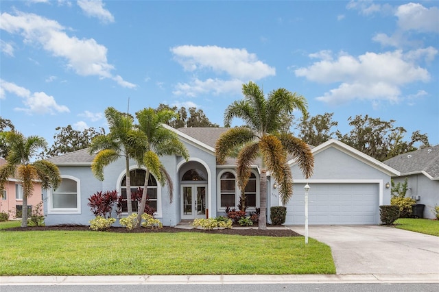 view of front of home featuring a garage, a front yard, and french doors