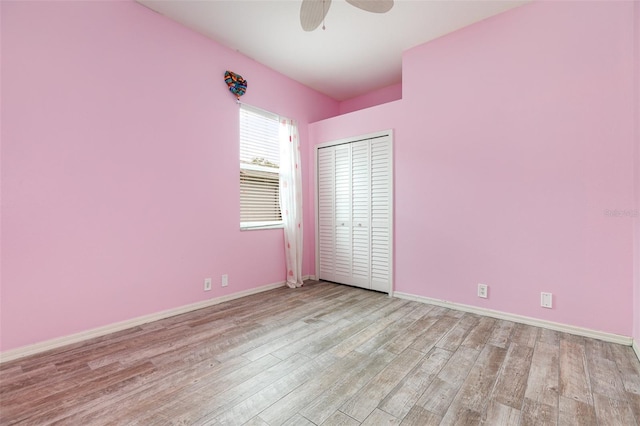 unfurnished bedroom with ceiling fan, a closet, and light hardwood / wood-style flooring