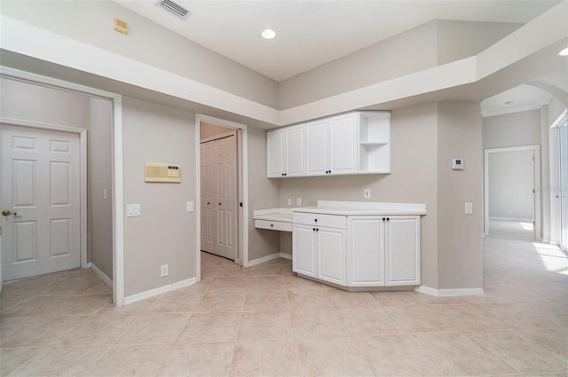 kitchen with white cabinets and light tile patterned floors