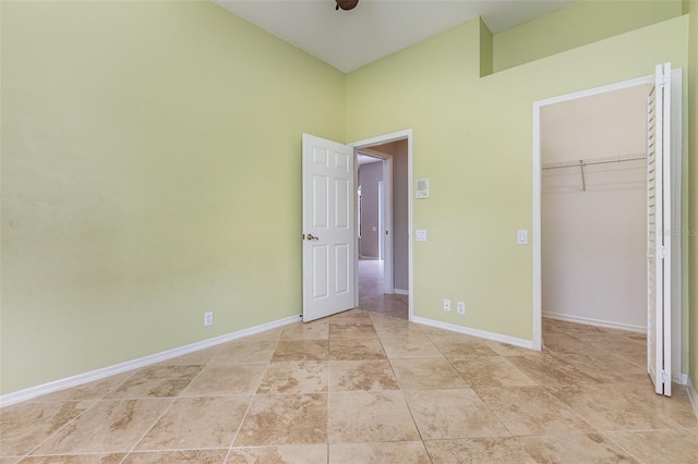 unfurnished bedroom with a spacious closet and a closet