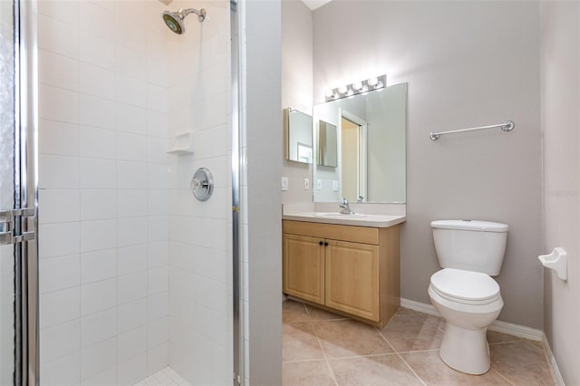 bathroom featuring tile patterned floors, vanity, toilet, and walk in shower