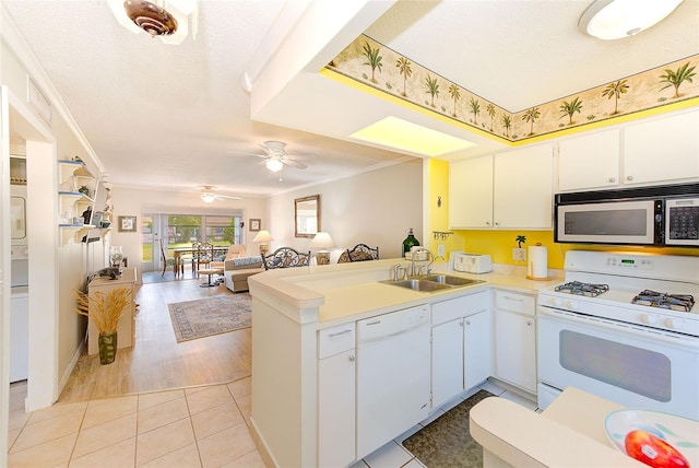 kitchen featuring white appliances, white cabinetry, ceiling fan, and kitchen peninsula