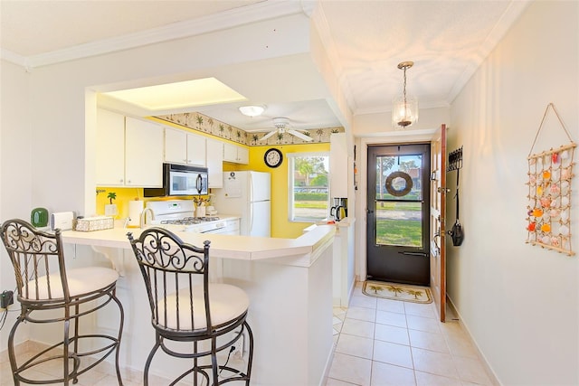 kitchen featuring white cabinets, ornamental molding, kitchen peninsula, and white appliances