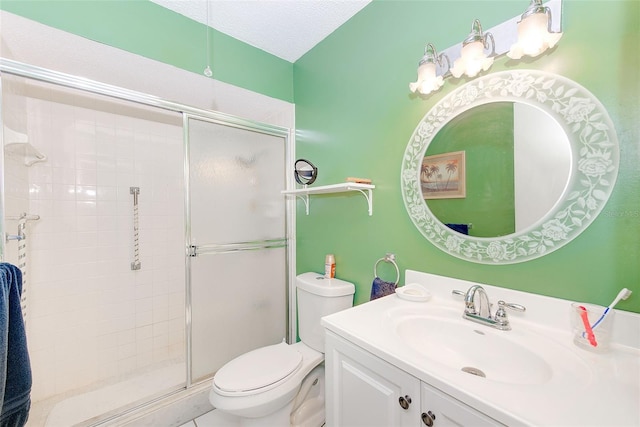 bathroom featuring walk in shower, vanity, toilet, and a textured ceiling