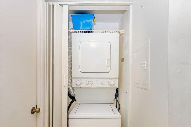 laundry area with stacked washer and clothes dryer