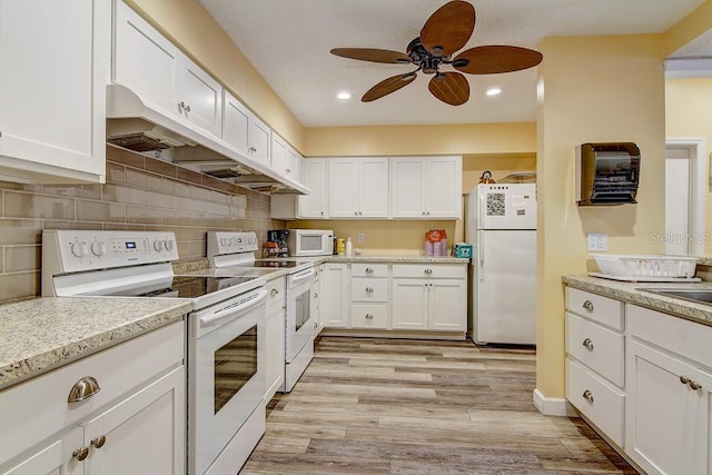 kitchen with light wood-type flooring, white cabinetry, custom range hood, white appliances, and ceiling fan