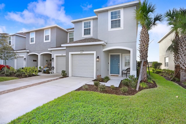 view of front of home featuring a front yard and a garage