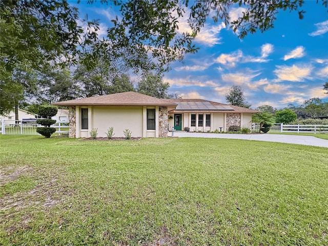 ranch-style house with a front lawn