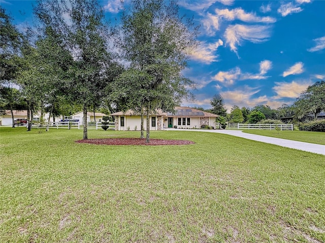 ranch-style home with a front lawn