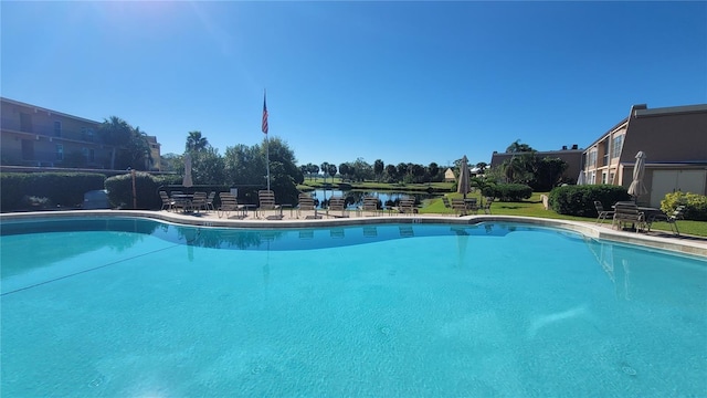 view of swimming pool with a water view