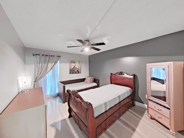 tiled bedroom with ceiling fan