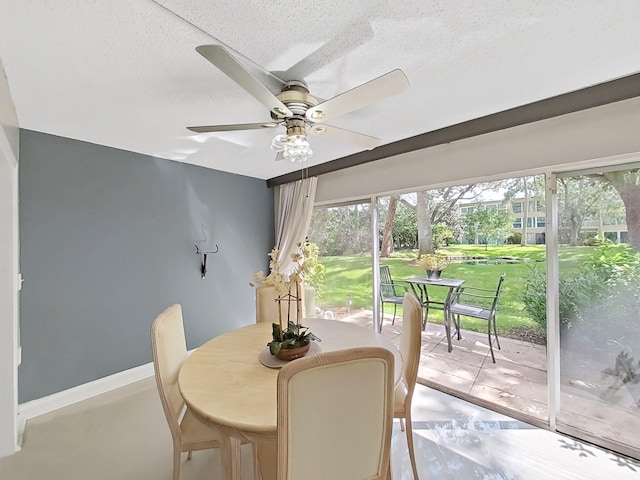 dining area with a textured ceiling and ceiling fan