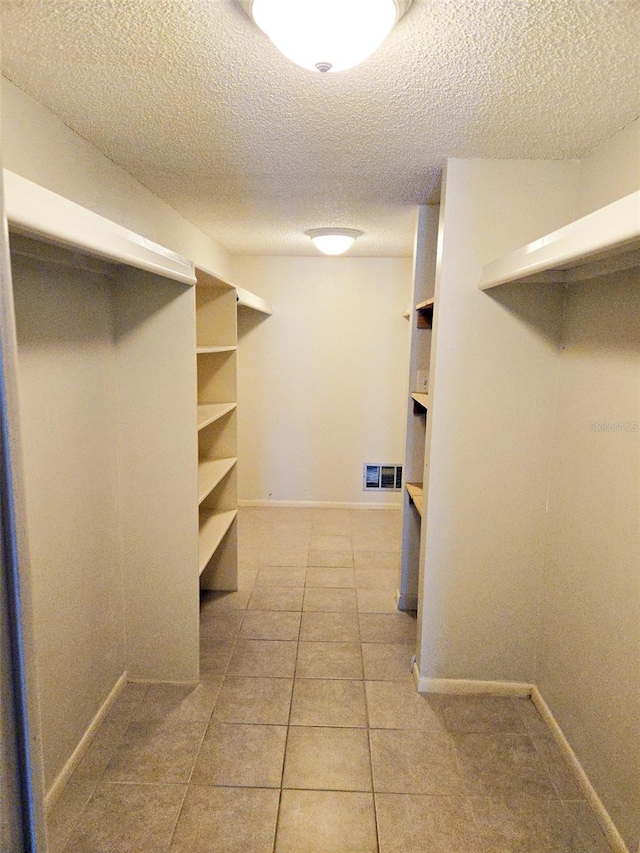 walk in closet featuring light tile patterned floors