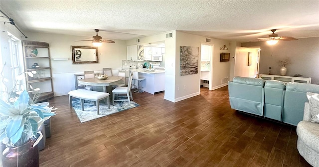 dining area featuring a textured ceiling and dark wood-type flooring